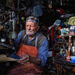 Old Turkish man manages a shoe repair shop