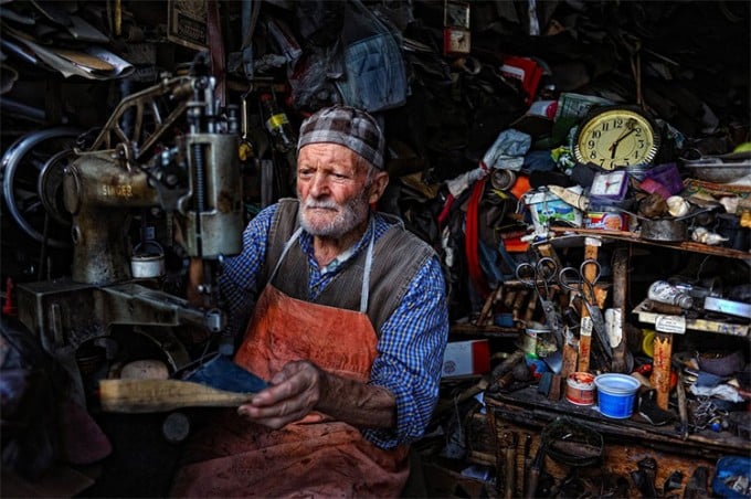 Old Turkish man manages a shoe repair shop