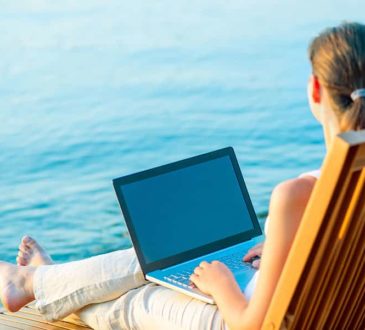 Business Woman with Laptop on beach