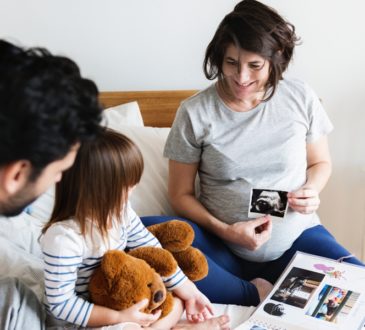 Pregnant family looking through a family photo album