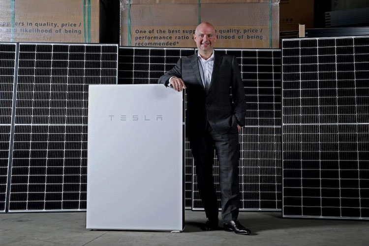 Natural Solar CEO Chris Williams with a Tesla Powerwall